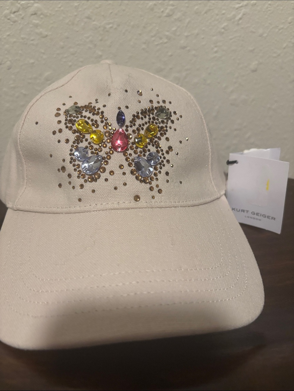 Kurt Geiger Cream Baseball Cap with Jeweled Butterfly